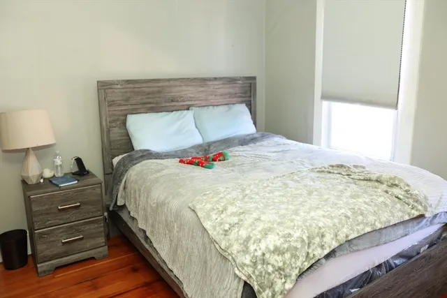 a bedroom with a bed and window