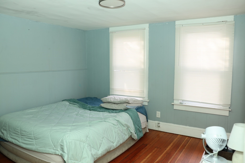 62-64 Whittier Street Springfield, MA 01108 - Photo 23 of 30 a bedroom with a bed and window