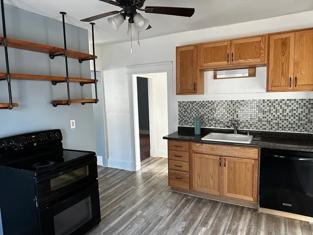a kitchen with stainless steel appliances granite countertop a stove and a refrigerator