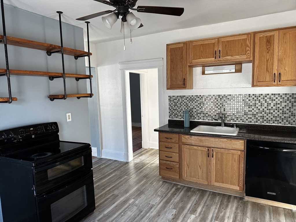 62-64 Whittier Street Springfield, MA 01108 - Photo 3 of 30 a kitchen with stainless steel appliances granite countertop a stove and a refrigerator