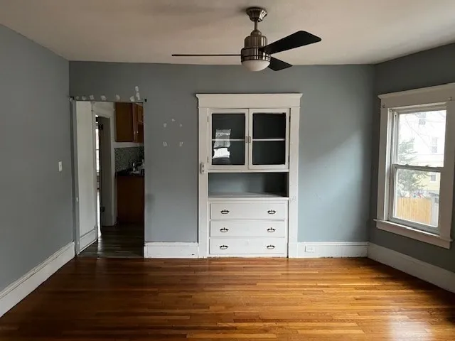 wooden floor in an empty room with a window