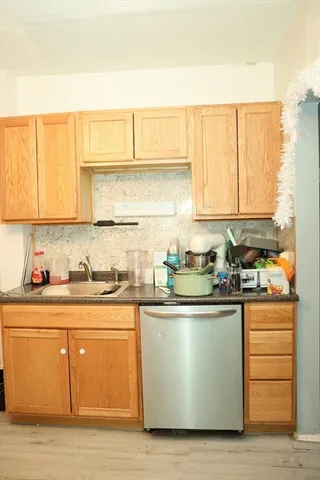 a kitchen with stainless steel appliances granite countertop a sink and a stove