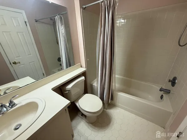 a bathroom with a sink a toilet and a mirror