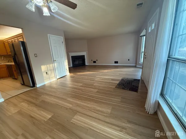 a view of a livingroom with wooden floor and staircase