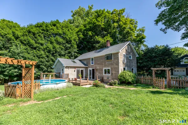 a house view with swimming pool and garden space