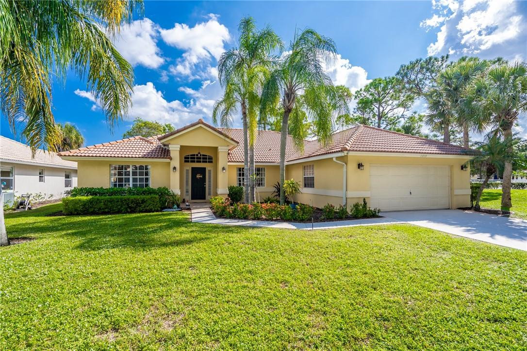 1315 Sabal Lakes Road Delray Beach, FL 33445 - Photo 1 of 38 a front view of a house with a yard and garage