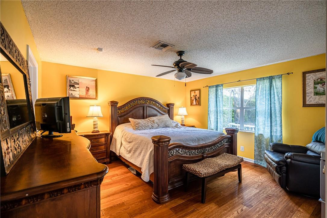 1315 Sabal Lakes Road Delray Beach, FL 33445 - Photo 13 of 38 a bedroom with bed and wooden floor