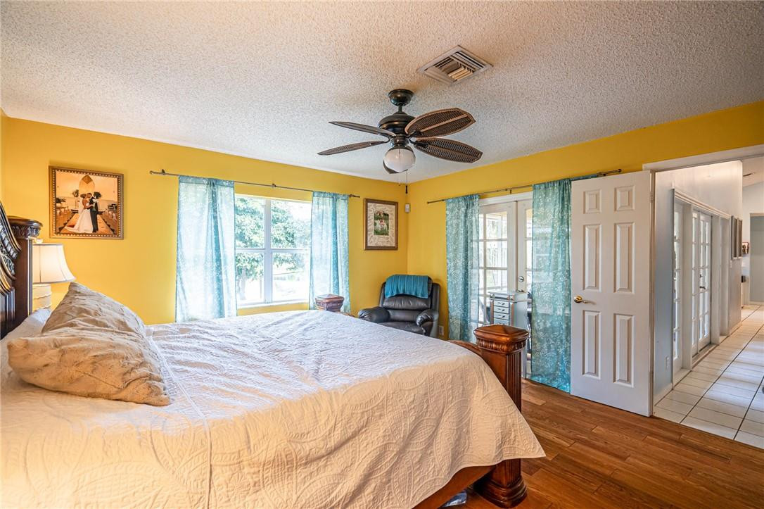 1315 Sabal Lakes Road Delray Beach, FL 33445 - Photo 14 of 38 a bed sitting in a bedroom next to a window