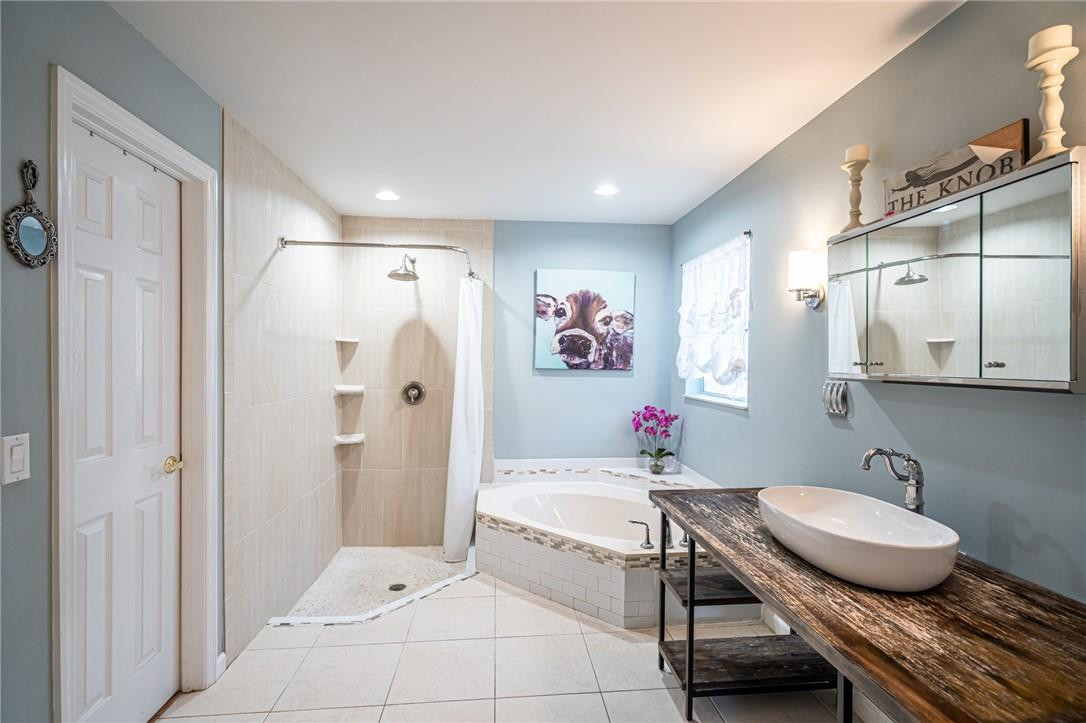 1315 Sabal Lakes Road Delray Beach, FL 33445 - Photo 15 of 38 a bathroom with a granite countertop sink a mirror and a shower