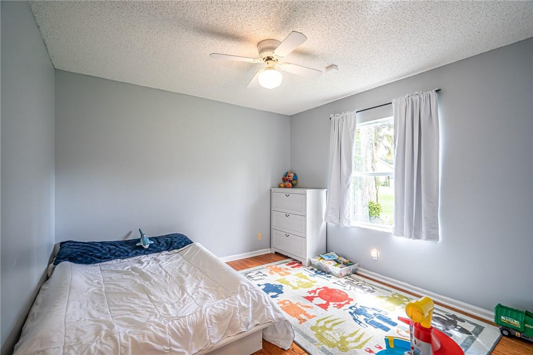 1315 Sabal Lakes Road Delray Beach, FL 33445 - Photo 20 of 38 a bedroom with a bed and a chandelier