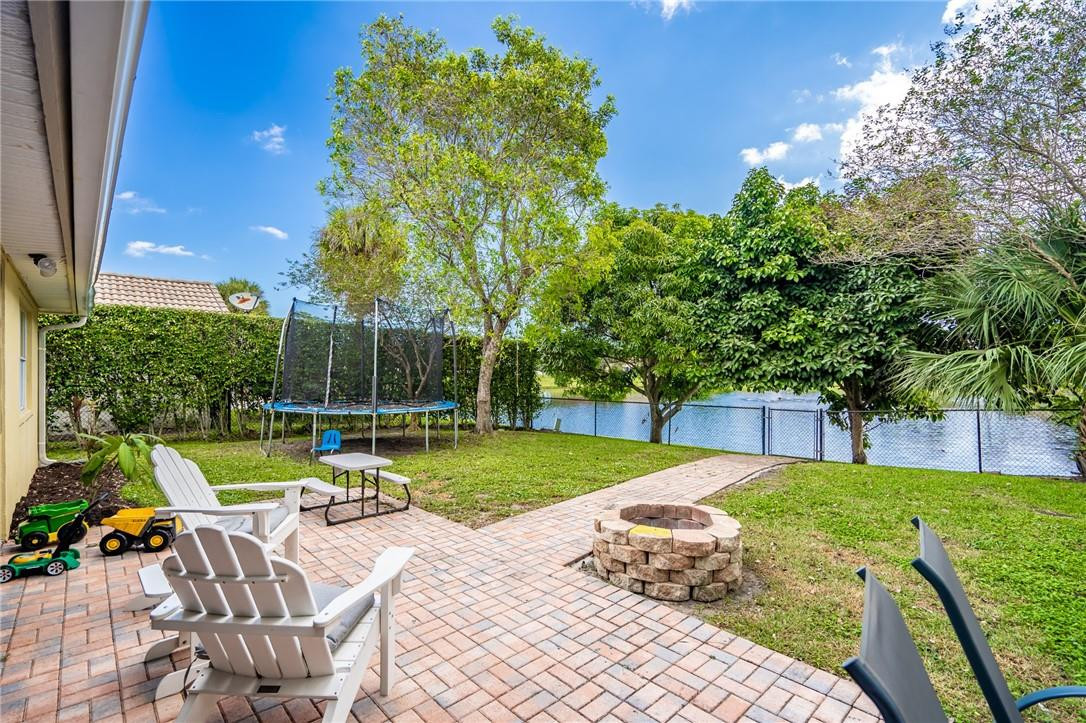 1315 Sabal Lakes Road Delray Beach, FL 33445 - Photo 28 of 38 a view of backyard with swimming pool and patio