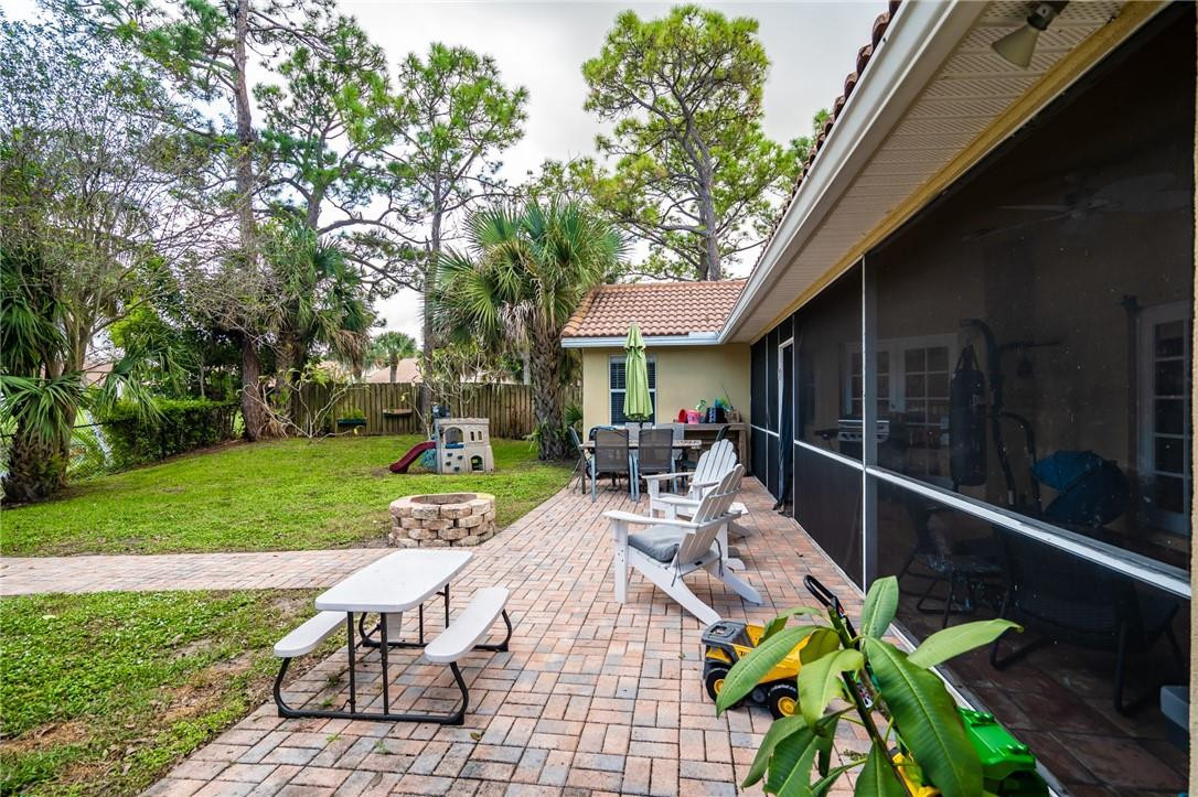 1315 Sabal Lakes Road Delray Beach, FL 33445 - Photo 29 of 38 a view of a patio with table and chairs with wooden fence and plants