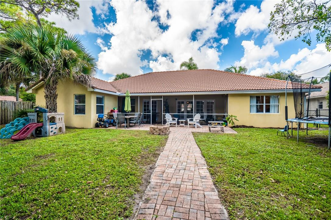 1315 Sabal Lakes Road Delray Beach, FL 33445 - Photo 30 of 38 a front view of a house with a yard porch and seating area