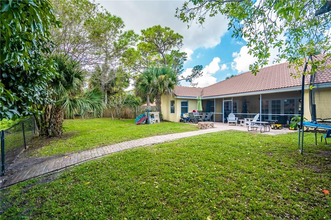 1315 Sabal Lakes Road Delray Beach, FL 33445 - Photo 31 of 38 a view of a house with swimming pool and a yard
