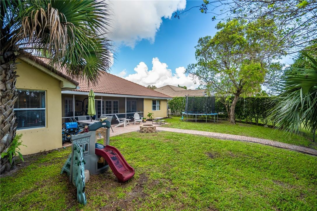 1315 Sabal Lakes Road Delray Beach, FL 33445 - Photo 32 of 38 a view of a house with swimming pool and sitting area