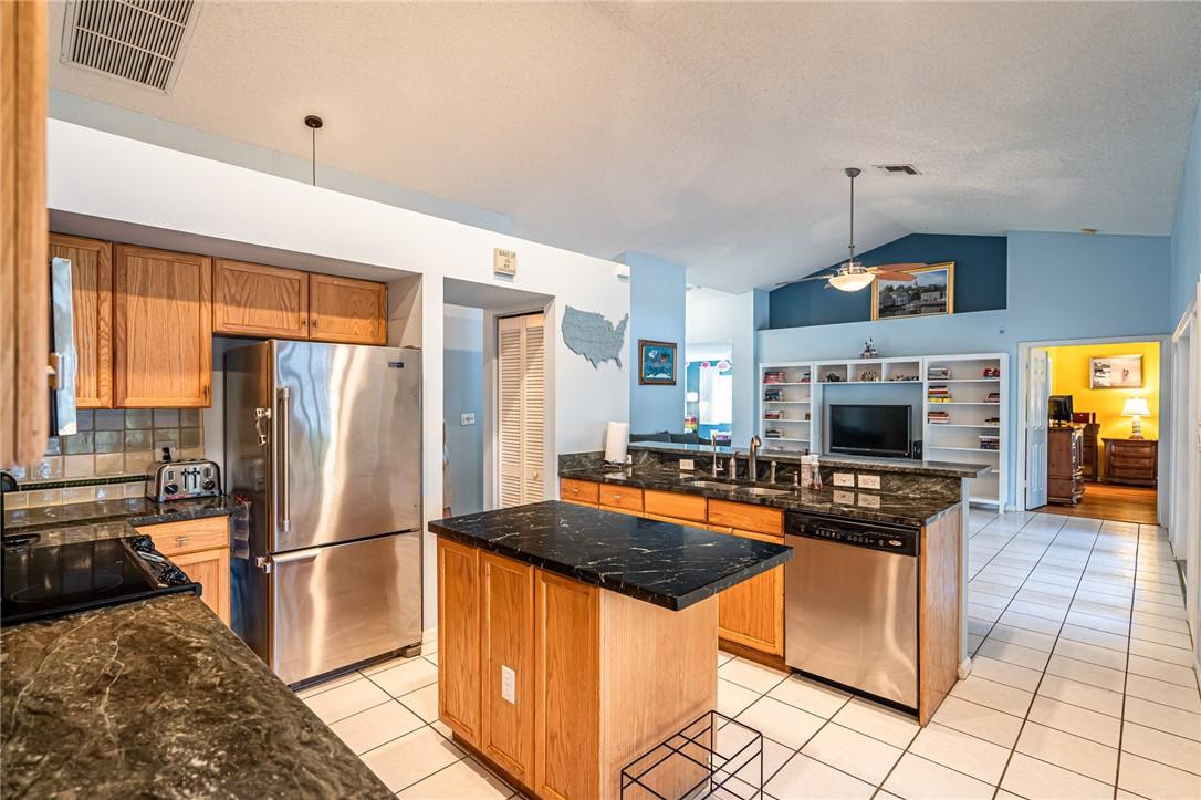 1315 Sabal Lakes Road Delray Beach, FL 33445 - Photo 4 of 38 a kitchen with stainless steel appliances granite countertop a stove refrigerator and a oven