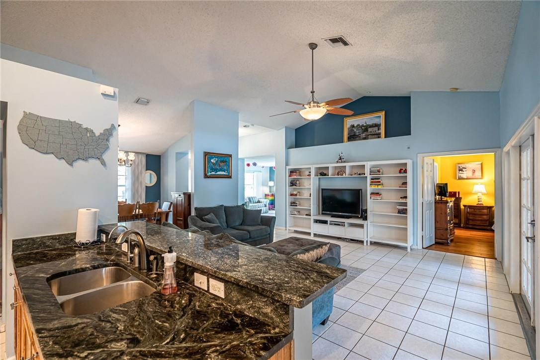 1315 Sabal Lakes Road Delray Beach, FL 33445 - Photo 5 of 38 a kitchen with stainless steel appliances granite countertop a sink and a microwave