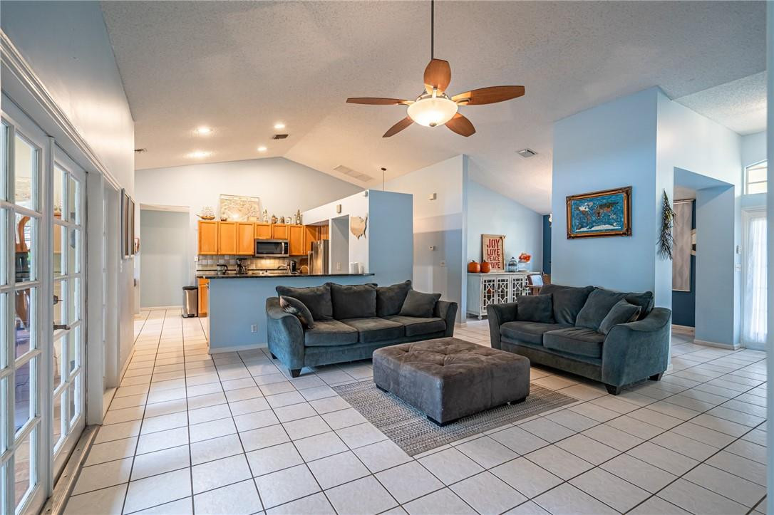 1315 Sabal Lakes Road Delray Beach, FL 33445 - Photo 6 of 38 a living room with furniture and a chandelier