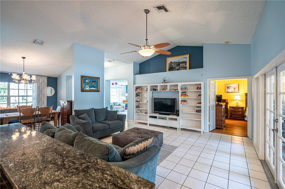 1315 Sabal Lakes Road Delray Beach, FL 33445 - Photo 7 of 38 a living room with furniture a fireplace and a flat screen tv