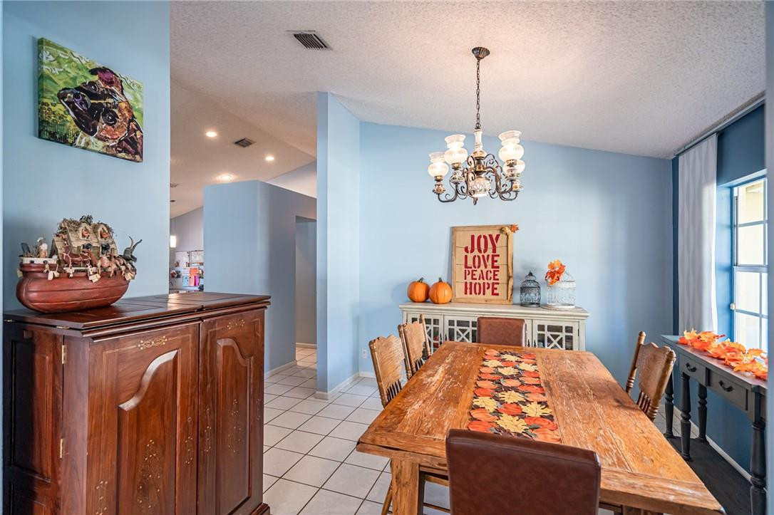 1315 Sabal Lakes Road Delray Beach, FL 33445 - Photo 9 of 38 a bedroom with a bed and a chandelier