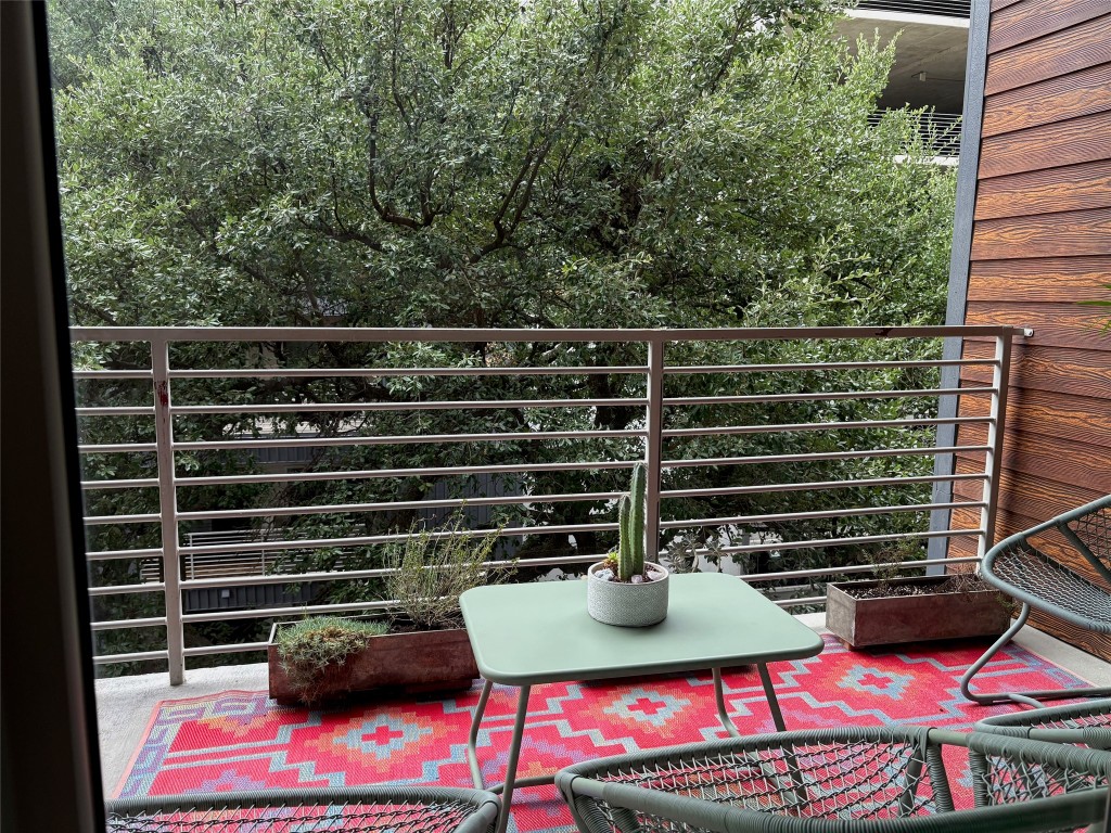 4361 South Congress Avenue, Unit 335 Austin, TX 78745 - Photo 5 of 22 a view of a balcony with two chairs and a potted plant