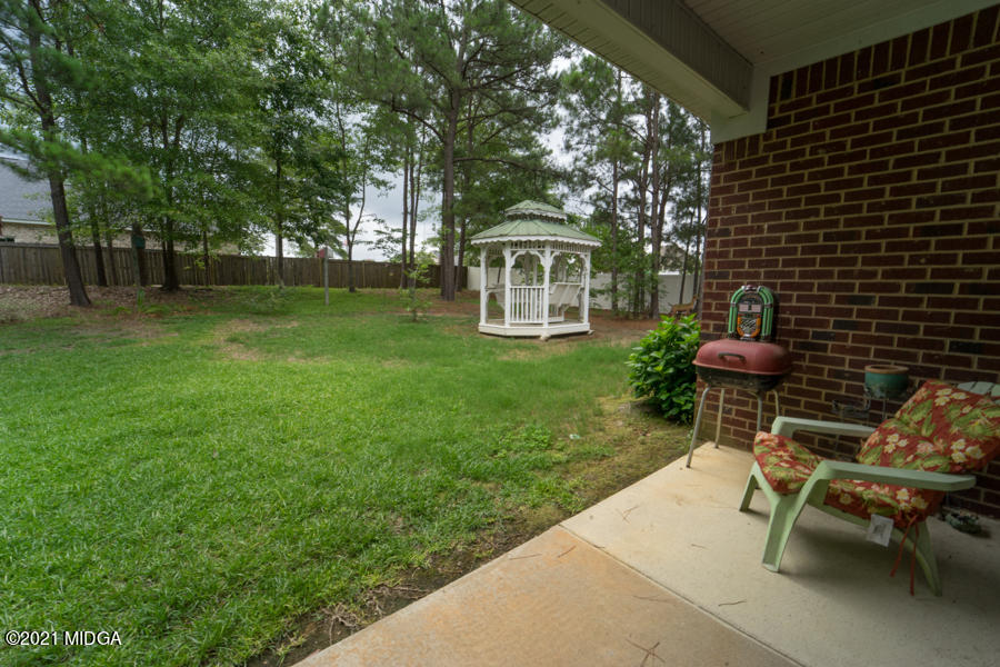 126 Timber Ridge Boulevard Byron, GA 31008 - Photo 18 of 26 a view of a backyard with table and chairs and a large tree