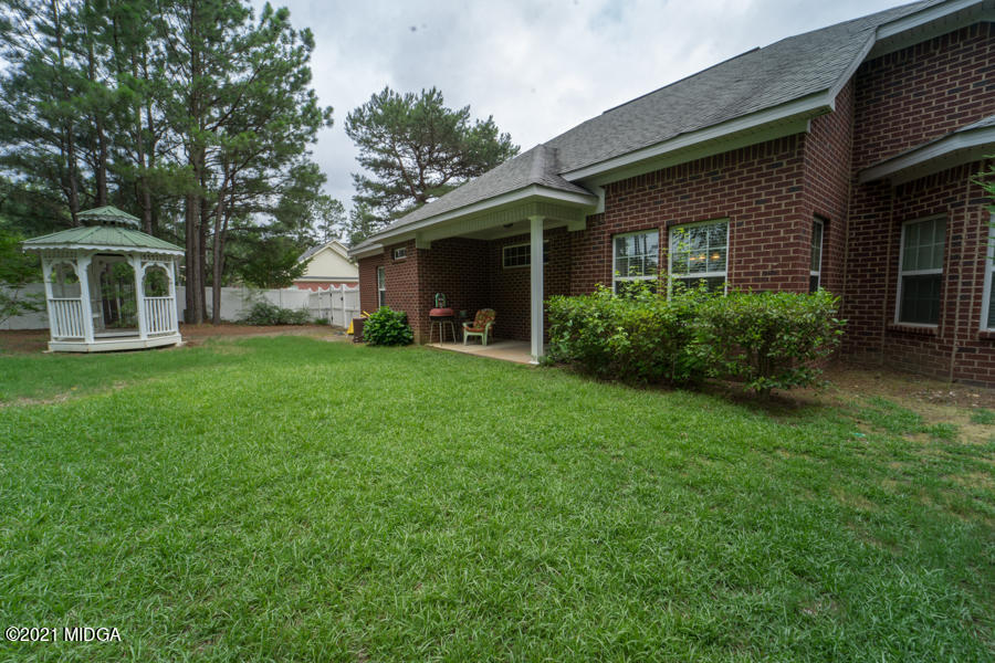 126 Timber Ridge Boulevard Byron, GA 31008 - Photo 22 of 26 a front view of a house with a yard and trees