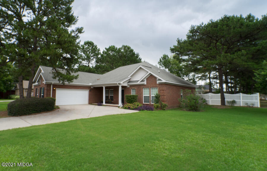 126 Timber Ridge Boulevard Byron, GA 31008 - Photo 25 of 26 a front view of a house with a garden and trees
