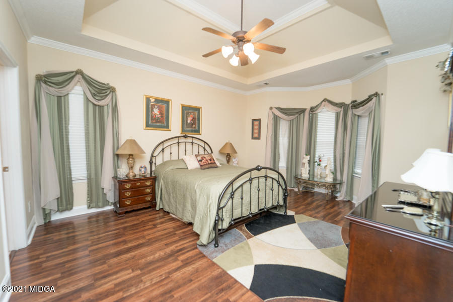126 Timber Ridge Boulevard Byron, GA 31008 - Photo 6 of 26 a bedroom with a bed and a chandelier