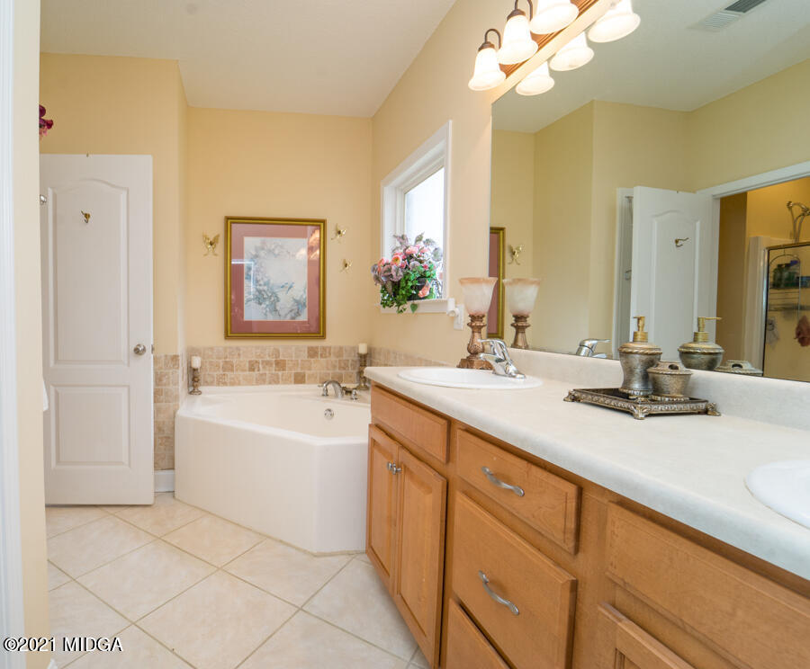 126 Timber Ridge Boulevard Byron, GA 31008 - Photo 7 of 26 a bathroom with a tub sink and mirror