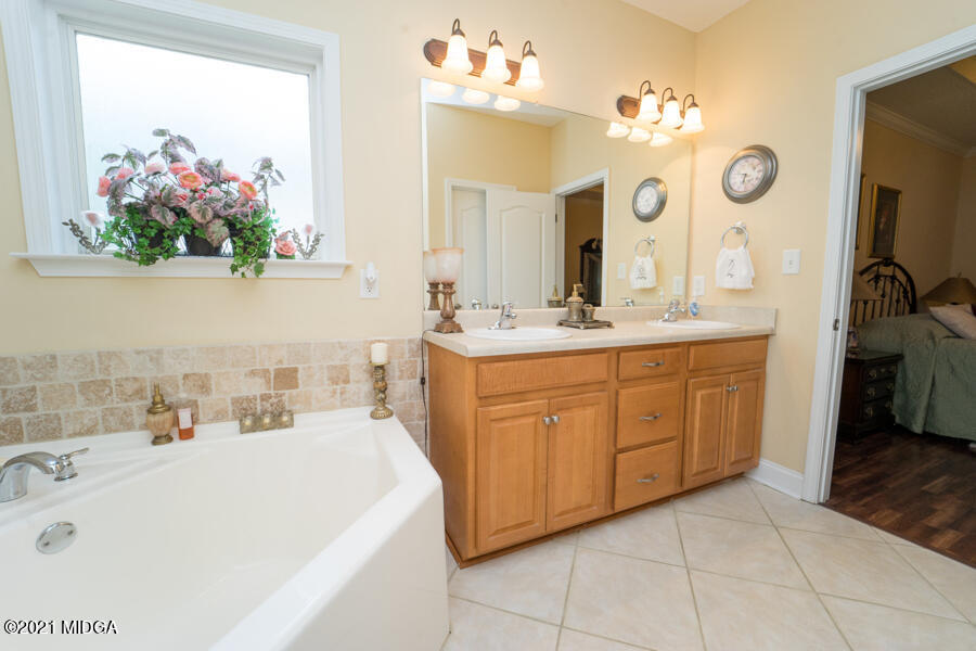 126 Timber Ridge Boulevard Byron, GA 31008 - Photo 9 of 26 a bathroom with a sink vanity and mirror