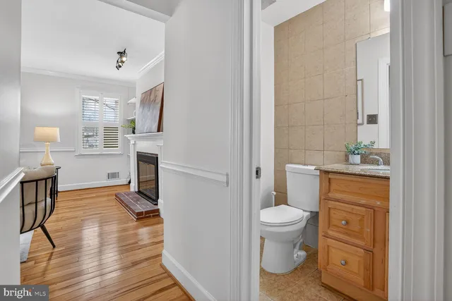 a view of a hallway with wooden floor and dining room