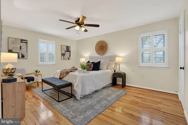 a living room with furniture and a dining table with wooden floor