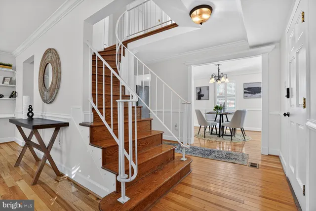 a living room with furniture a wooden floor and a large window