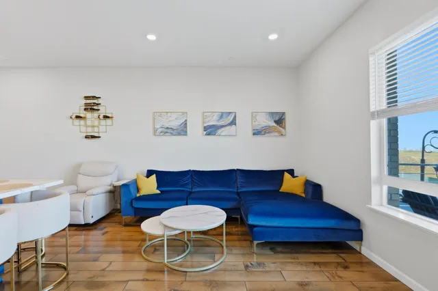 a living room with furniture and wooden floor