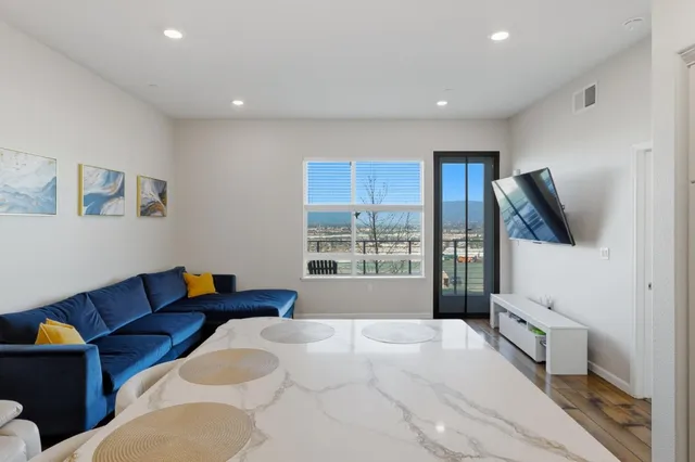 a bedroom with furniture and a large window