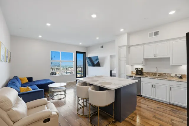 a kitchen with a stove a sink a dining table and chairs
