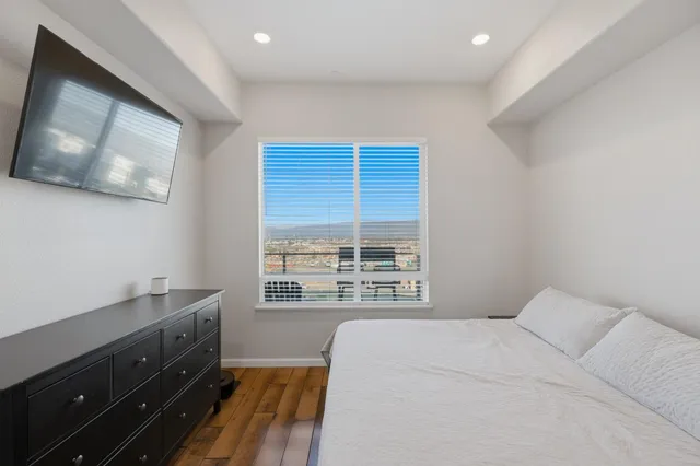 a bed room with a bed and a television