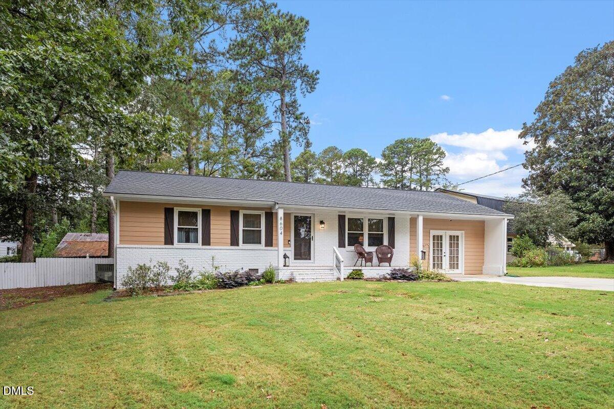 a front view of house with yard and green space