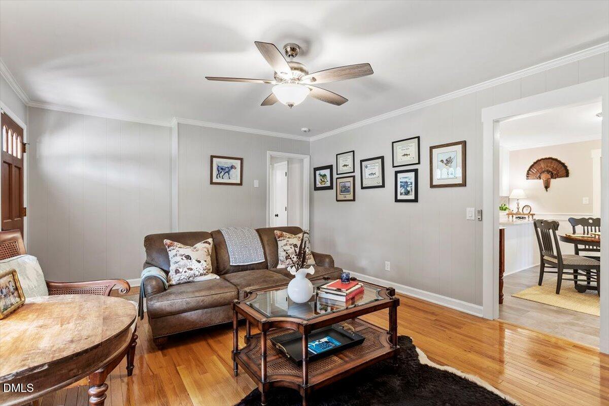 8604 Lobelia Street Raleigh, NC 27603 - Photo 11 of 27 a living room with furniture and wooden floor