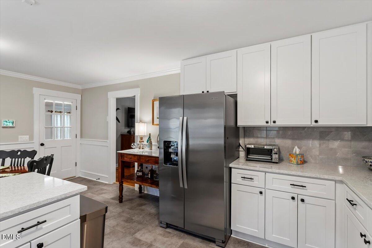 8604 Lobelia Street Raleigh, NC 27603 - Photo 17 of 27 a kitchen with stainless steel appliances a refrigerator sink and cabinets