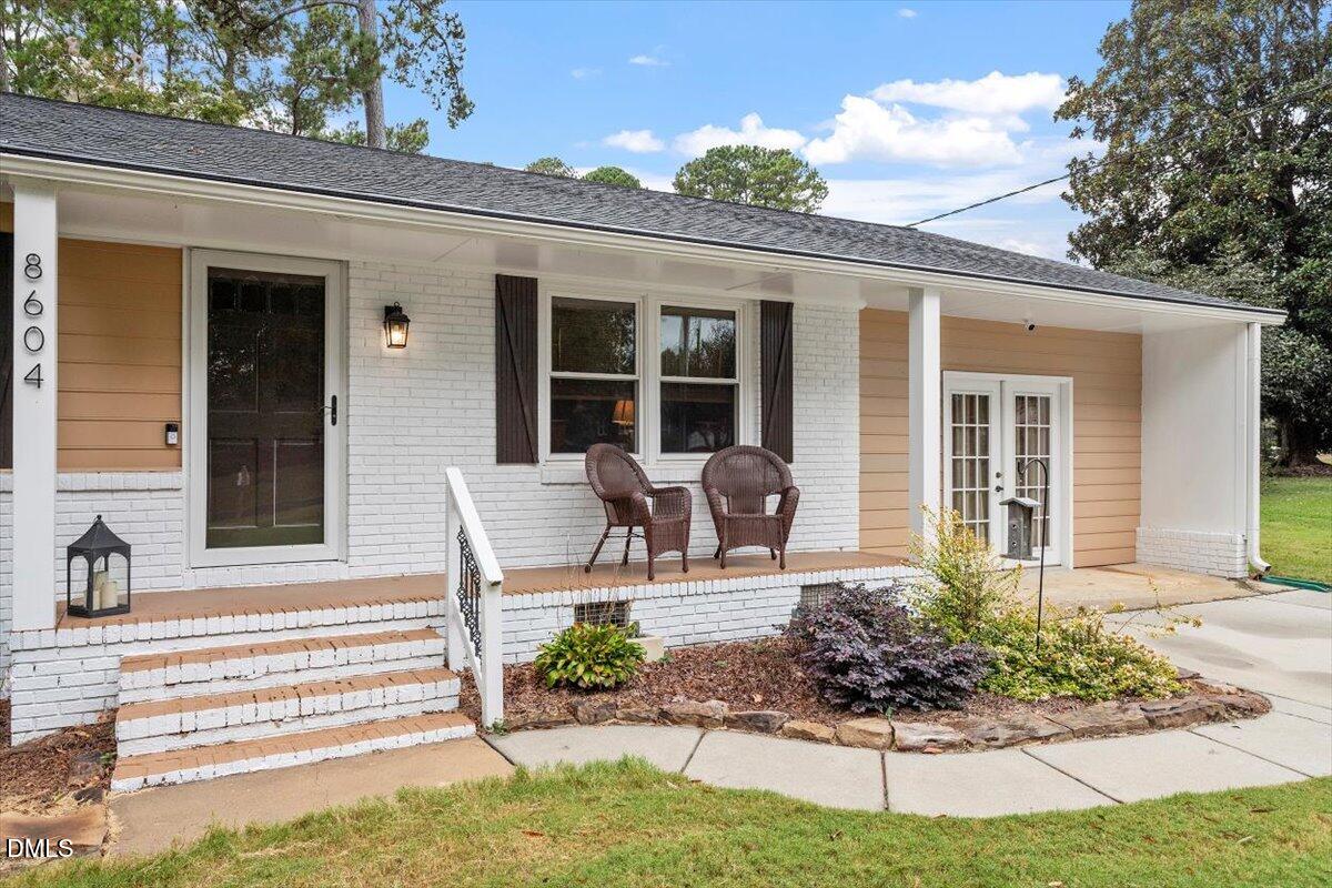 8604 Lobelia Street Raleigh, NC 27603 - Photo 2 of 27 a front view of a house with garden and porch