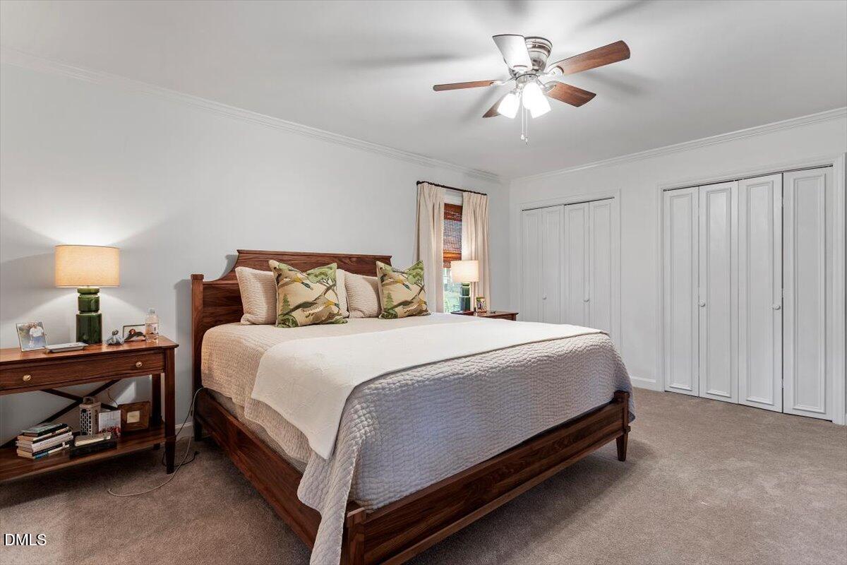 8604 Lobelia Street Raleigh, NC 27603 - Photo 21 of 27 a bedroom with a bed and a chandelier