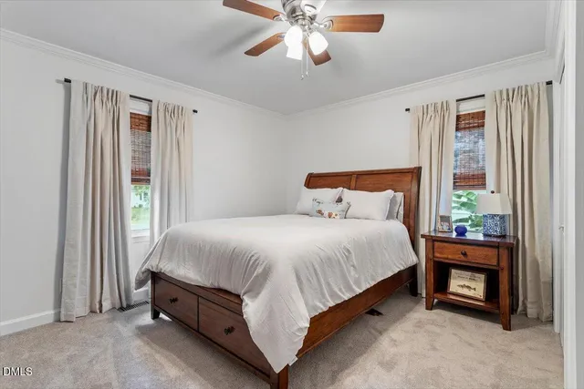 a bed sitting in a bedroom next to a window