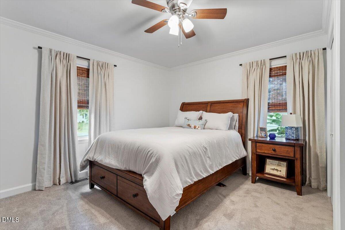 8604 Lobelia Street Raleigh, NC 27603 - Photo 22 of 27 a bed sitting in a bedroom next to a window