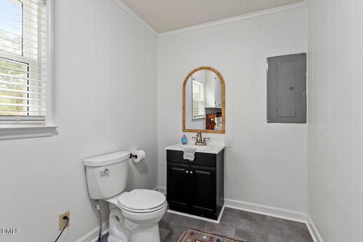 8604 Lobelia Street Raleigh, NC 27603 - Photo 24 of 27 a bathroom with a toilet sink and mirror