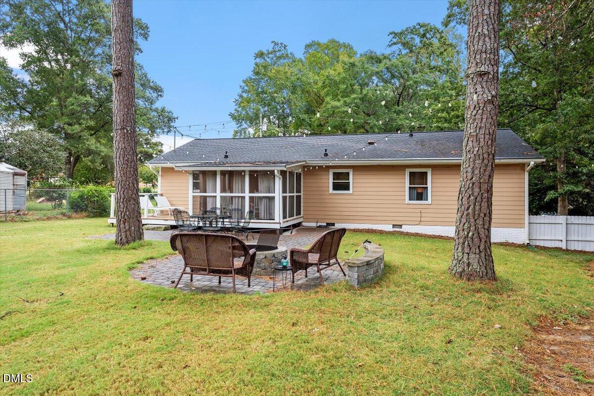 8604 Lobelia Street Raleigh, NC 27603 - Photo 5 of 27 a backyard of a house with yard and outdoor seating