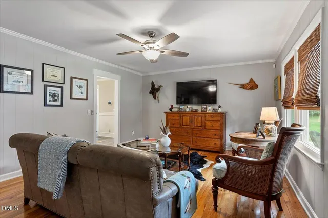 a bedroom with furniture and a flat screen tv