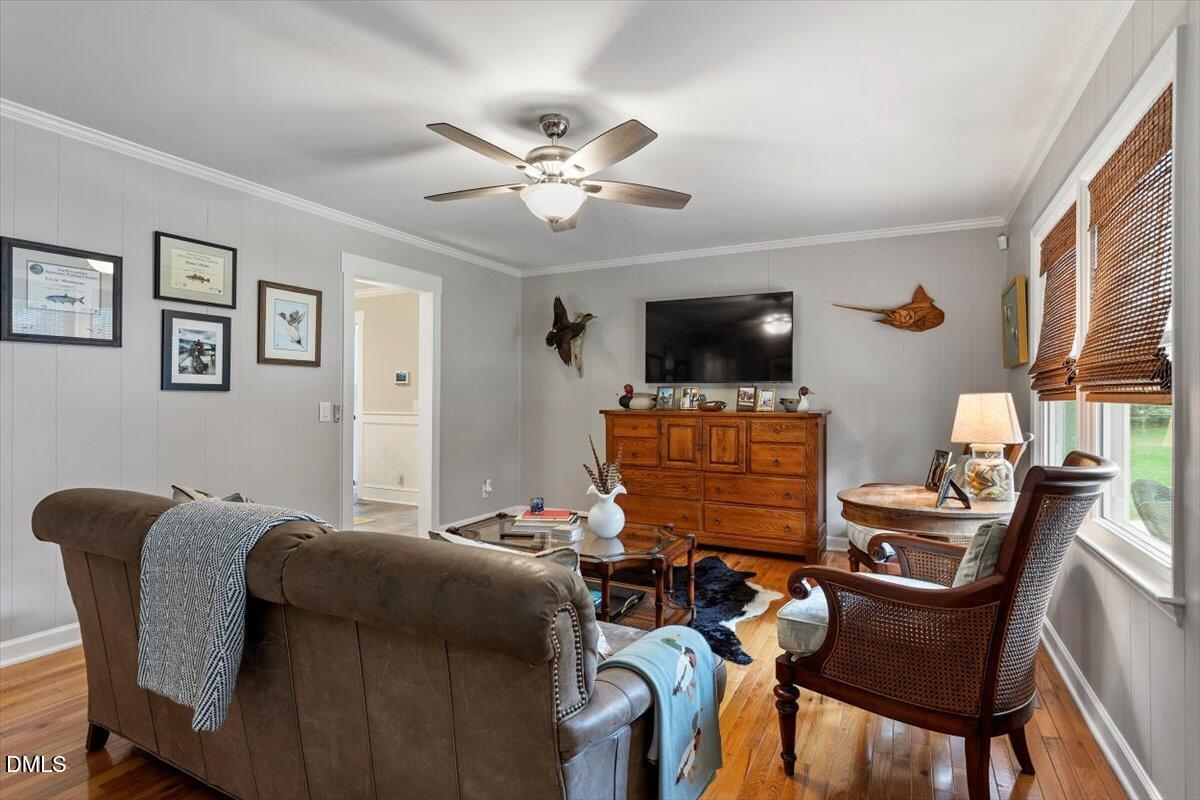 8604 Lobelia Street Raleigh, NC 27603 - Photo 8 of 27 a bedroom with furniture and a flat screen tv