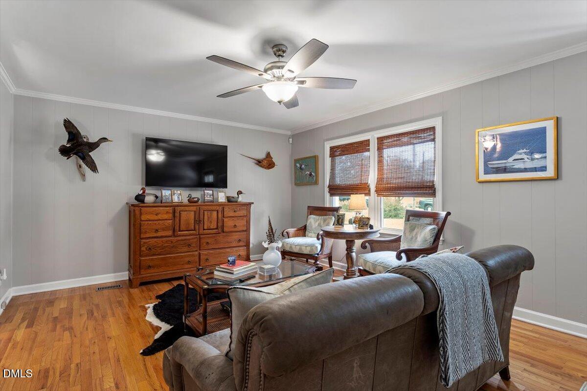 8604 Lobelia Street Raleigh, NC 27603 - Photo 9 of 27 a living room with furniture and a flat screen tv